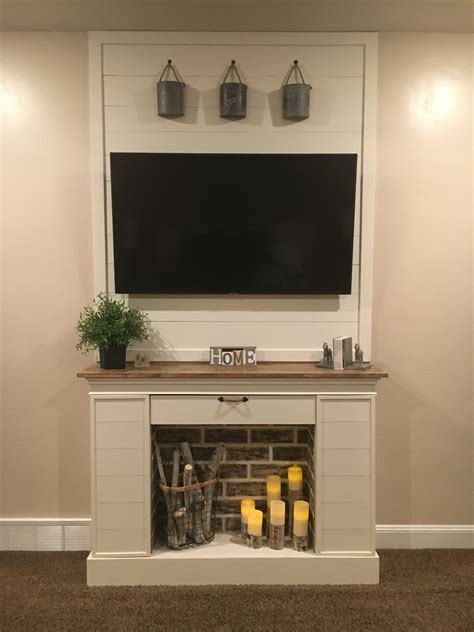 Custom beam style fireplace mantel with a drop front for hidden storage. Faux fireplace with hidden storage | Ana White