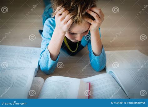 Boy Tired Of Reading Kid Stressed By Doing Homework Stock Photo