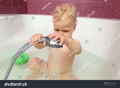 Cute Baby Boy Taking Shower In Bathroom Stock Photo