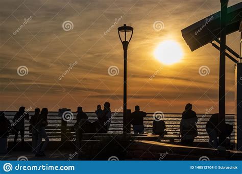 People Watch The Sunset Over The Pacific Ocean At La Jolla Beach