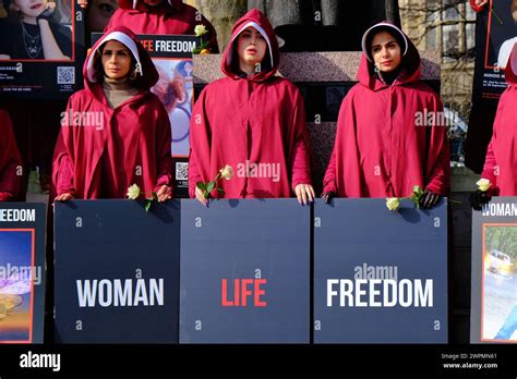 London, UK, 8th March, 2024. British-Iranians dressed in handmaids tale