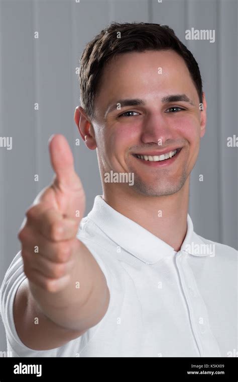 Portrait Of Young Man Showing Thumbs Up Sign Stock Photo Alamy