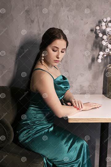 Attractive Brunette Woman In Elegant Green Aquamarine Dress In A Loft Cafe Beautiful Sensual