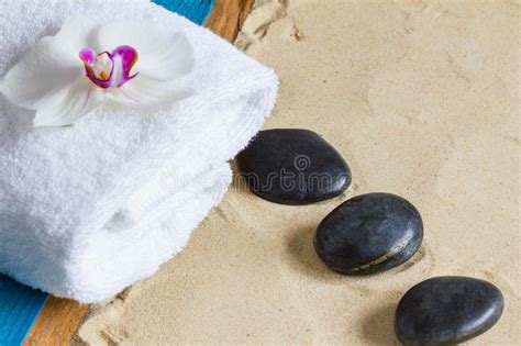 pampering therapy at the beach with hot stone massage stock image