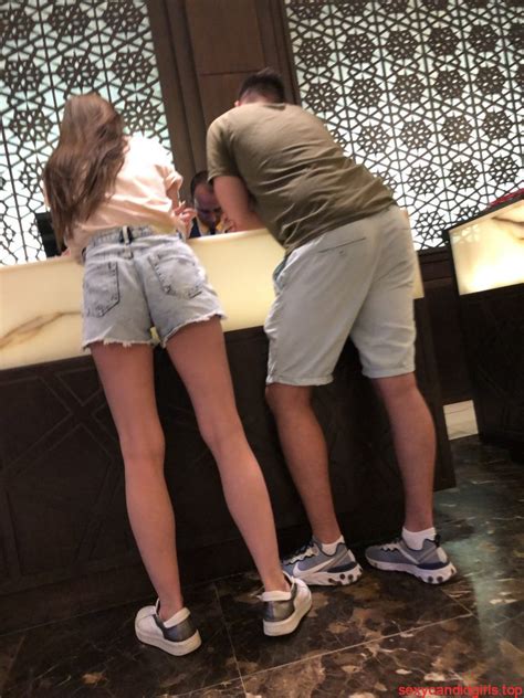 Girl With Skinny Legs In Denim Shorts Bending Over Candid