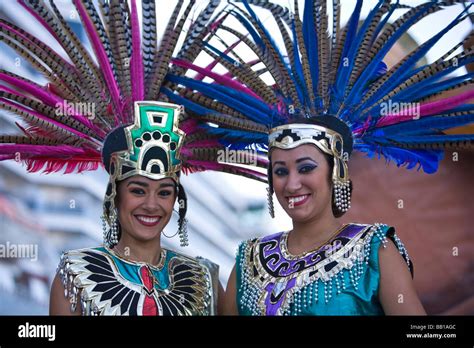 Two Women In Aztec Outfits Wearing Feather Headdress With Pheasant Feathers Cruise Ship