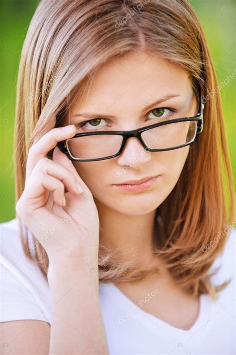 Portrait Of Strict Woman Looking Above Her Glasses Stock Photo By