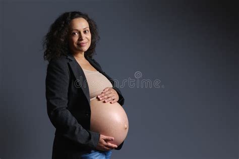 Happy Curly Multi Ethnic Pregnant Woman Gently Holding Her Naked Belly
