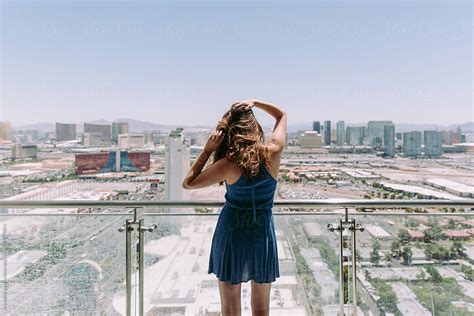 A Young Woman Standing On A Balcony In The Morning Overlooking The Las
