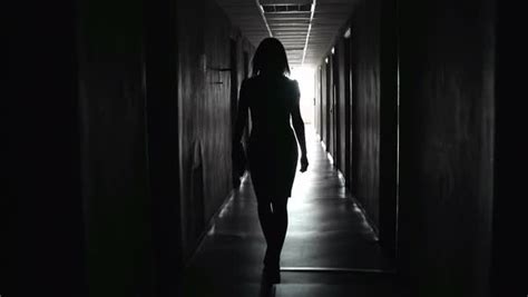 Outline Of Woman Walking In A Dark Hallway Stock Video Footage Dissolve