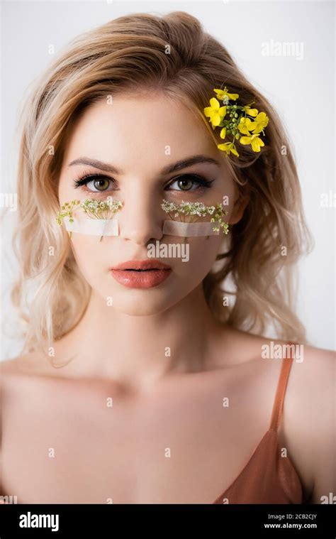 Beautiful Blonde Woman With Wildflowers Under Eyes Isolated On White