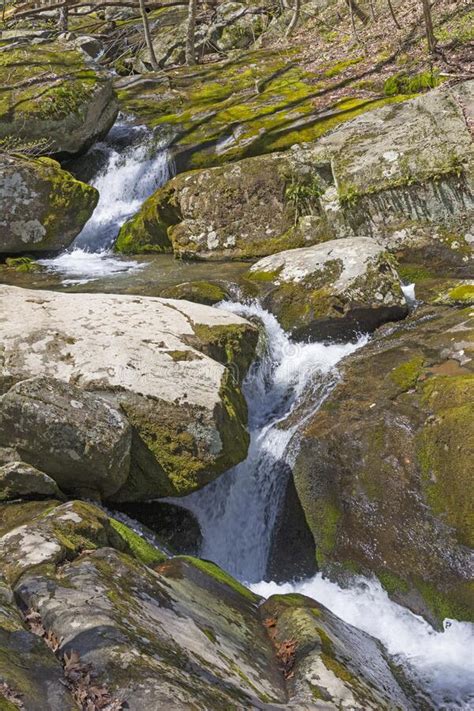 A Mountain Stream Cutting A Path Through The Mountain Rocks Stock Photo