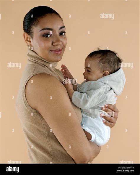 Mother Holding Her Baby She Is Six Months Old Stock Photo Alamy