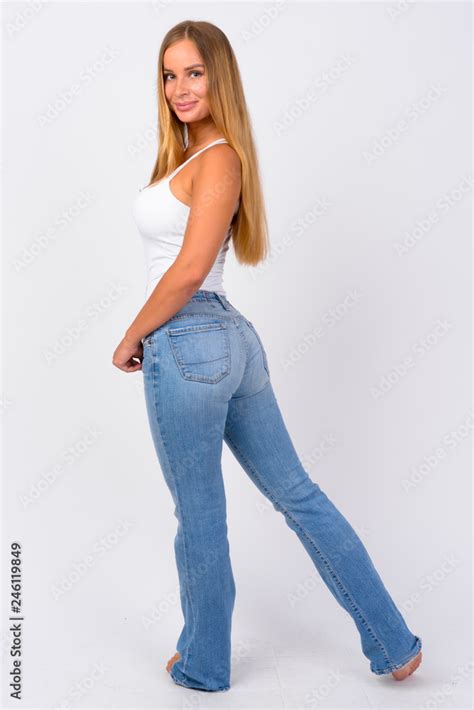 Full Body Shot Of Happy Young Beautiful Blonde Woman Looking Back Stock