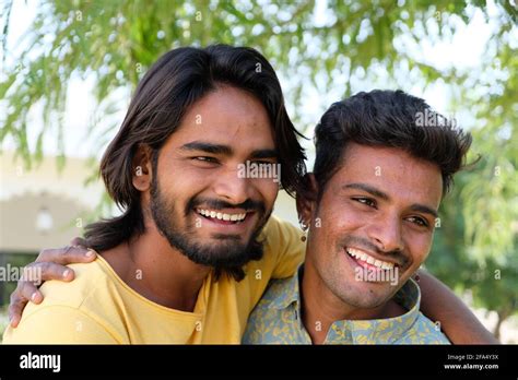 Portrait Of An Excited Indian Gay Couple Embracing And Smiling In A