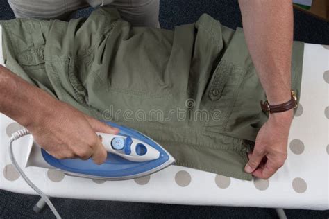 Hands Of Man Ironing Clothes On Ironing Board Stock Image Image Of