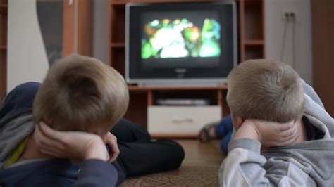 Boys Watching Tv Lying On The Floor Stock Video Footage Storyblocks