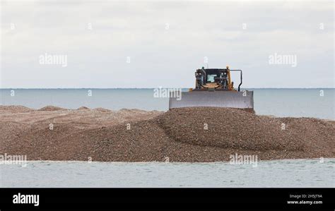 Heavy Digging And Moving Machinery Seen Working On Pagham Spit Stock Photo Alamy