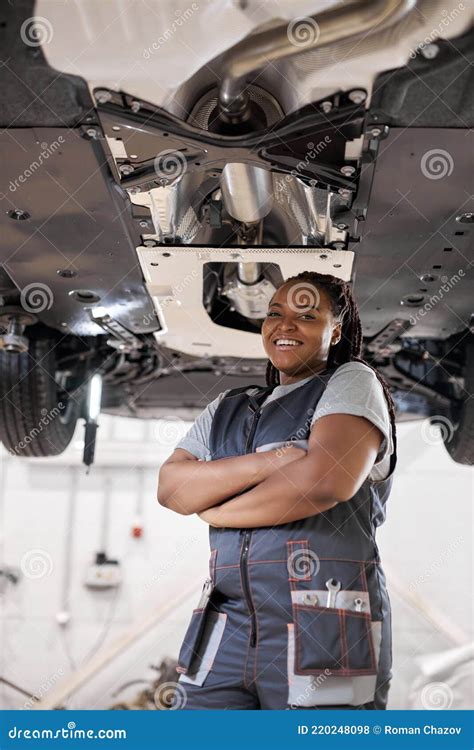 Professional Black Female Mechanic Posing At Camera Standing In Auto Repair Shop Stock Photo