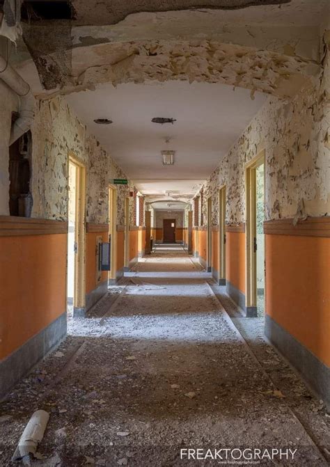 Decaying Hallway And Patient Rooms In Abandoned Psychiatric Hospital