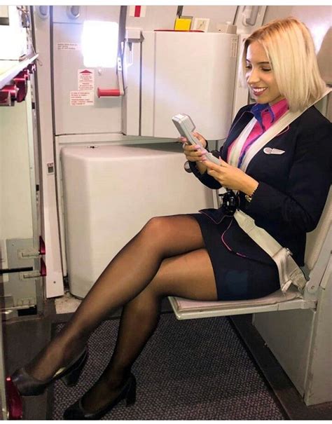 Flight Attendant Checking Phone On Airplane