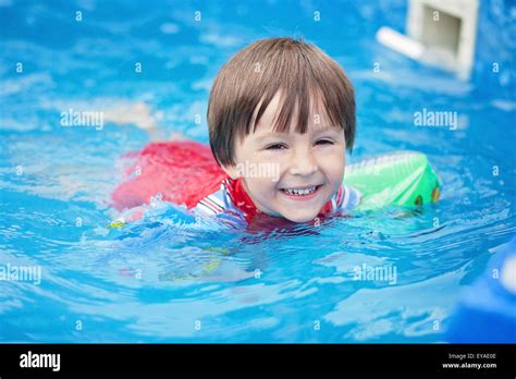 Sweet Little Boy Swimming In Big Swimming Pool Summertime Stock Photo