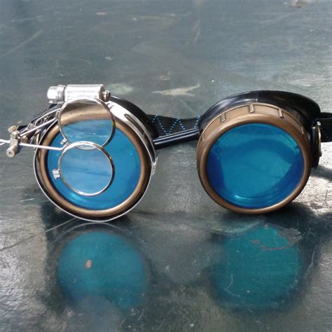 black and bronze steampunk goggles with blue lenses and double eye loupe steampunk goggles