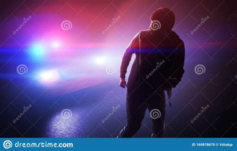 Silhouette Of Young Man Thief Escaping From Police Car At Night