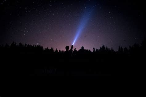 Silhouette Of Person Holding Flashlight During Nighttime Hd Wallpaper