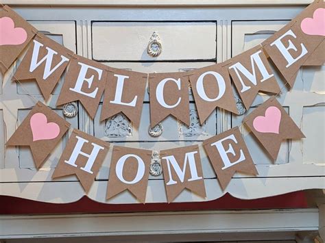 A Welcome Home Banner With Hearts On It