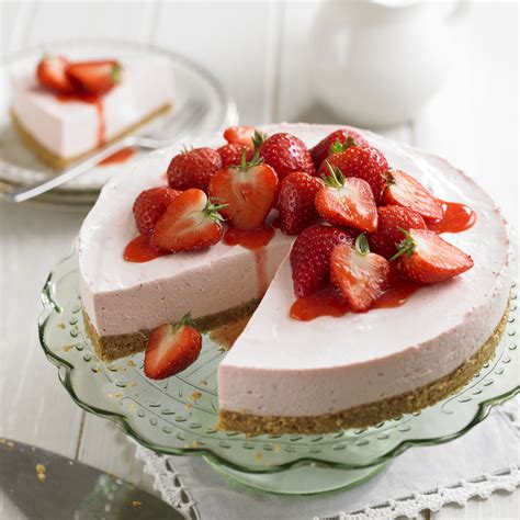 Strawberry cake and many fresh strawberries. Strawberry Cheesecake with Strawberry Sauce