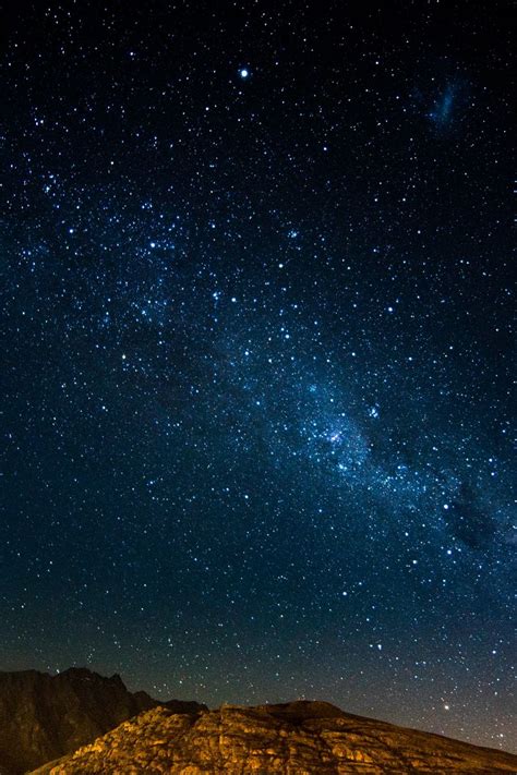 Download Wallpaper 800x1200 Starry Sky Night Mountains Radiance