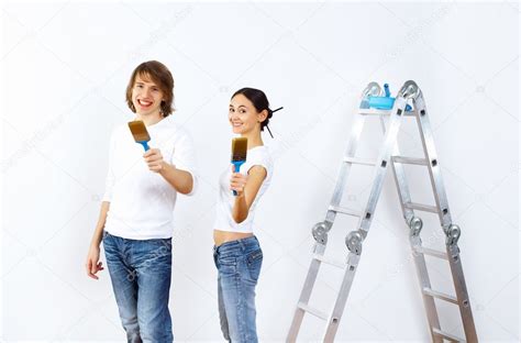 Young Couple With Paint Brushes Together — Stock Photo © Sergeynivens