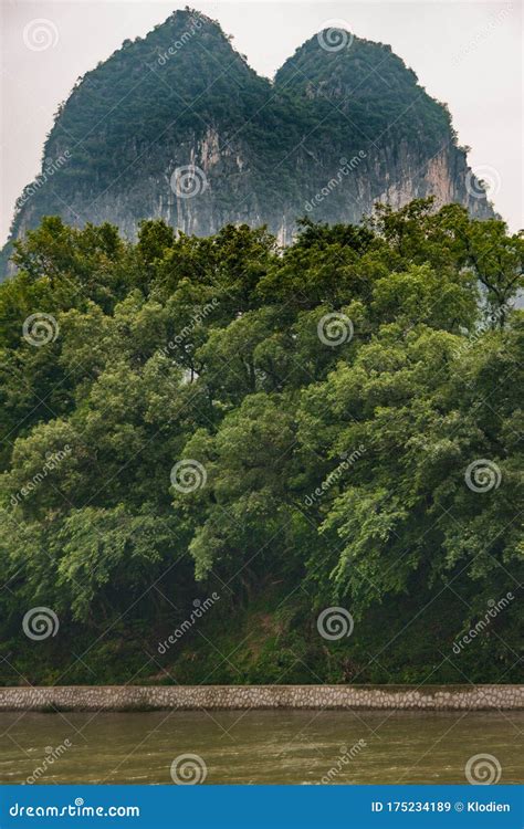 Twin Karst Mountains Towering Above Li River In Guilin China Stock