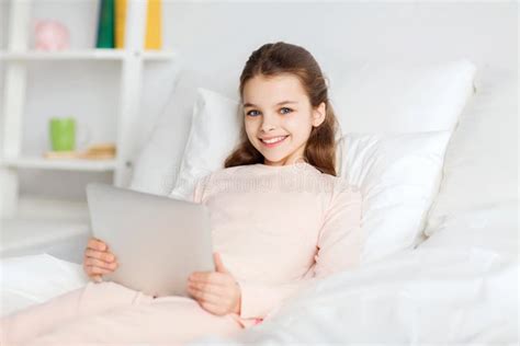 Happy Girl Lying In Bed With Tablet Pc At Home Stock Image Image Of