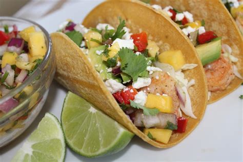 Shrimp tacos get a boost of heartiness from red rice simmered with chicken stock and tomato make the shrimp: Shrimp Tacos with Mango Salsa - Forks 'n' Flip Flops