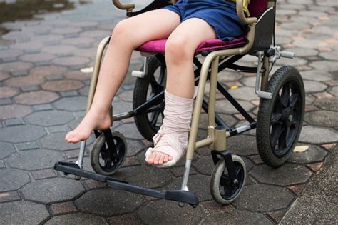 Premium Photo Leg Broken Boy Sit On Wheelchair
