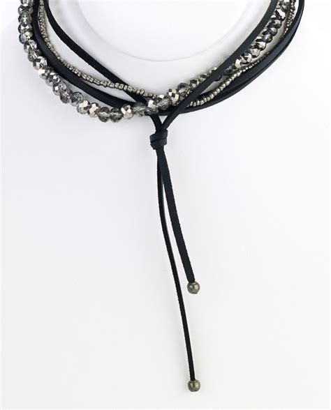 A Black Leather Choker Of Multiple Strands Wrapped With Silver And Gray