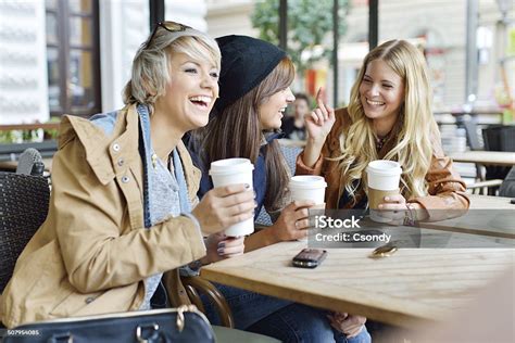 Young Friends Drinking Coffee Together In The City Stock Photo