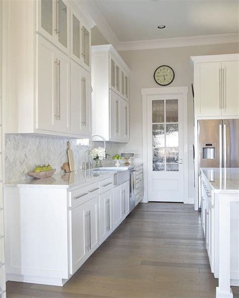 Gorgeous White Kitchen With White Carrara Marble And White Cabinets
