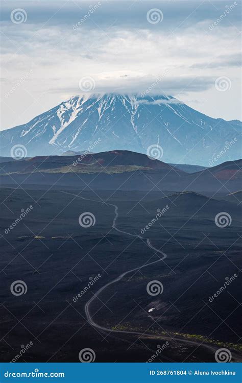 Road To Volcano Snowy Mountain Through Dark Lava Covered Ground And
