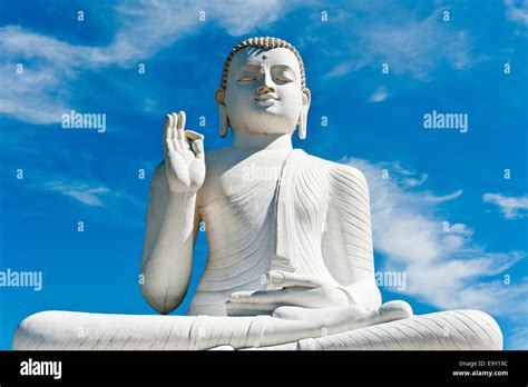 Theravada Buddhism White Statue Of Buddha Seated In The Lotus Position