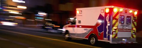 An Ambulance Speeding Through Traffic At Nighttime Smart Pain