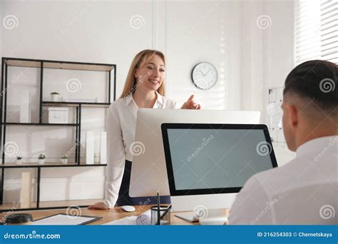 Young Woman Flirting With Her Colleague During Work In Office Stock