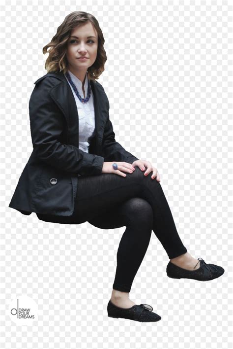 A Woman Sitting On The Ground With Her Legs Crossed And Wearing Black