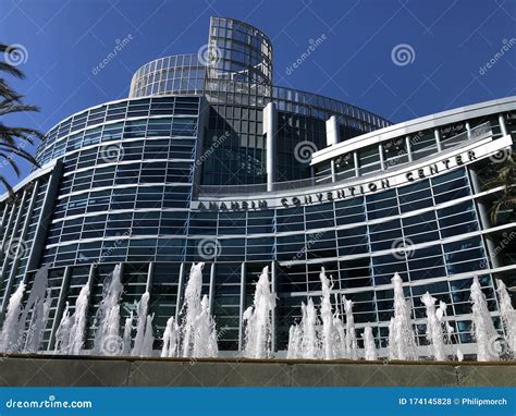 The Anaheim Convention Center In California With A Fountain In Front