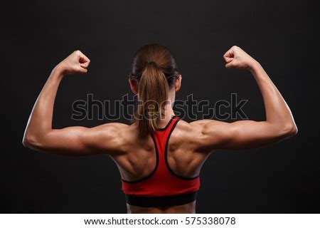 Back exercises are important for women and contribute to a strong, sculpted back along with great women's health may earn commission from the links on this page, but we only feature products we. Athletic Young Woman Showing Muscles Back Stock Photo ...