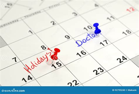 Red And Blue Pins Marking The Important Days On A Calendar Stock