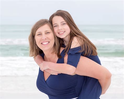 Two Women Hugging Each Other On The Beach