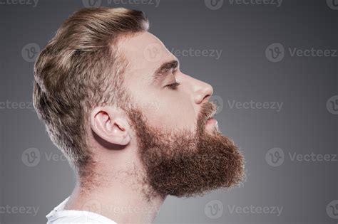 Bearded Handsome Side View Of Handsome Young Bearded Man Keeping Eyes
